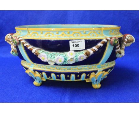 19th Century Staffordshire Majolica pottery oval planter, decorated with floral swags having mask mount handles on a dark and