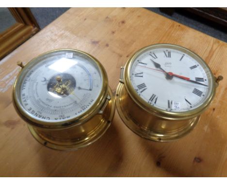 A brass ship's style wall clock and barometer  