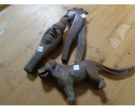Two antique cast iron nutcrackers in the form of a dog and a gnome, together with a further wooden nutcracker    