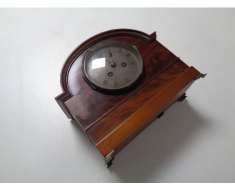 An Edwardian mahogany mantel clock with silvered dial on raised feet by Sorley of Glasgow 