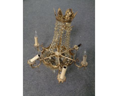 An antique ornate brass six way hanging light fitting with glass drops 