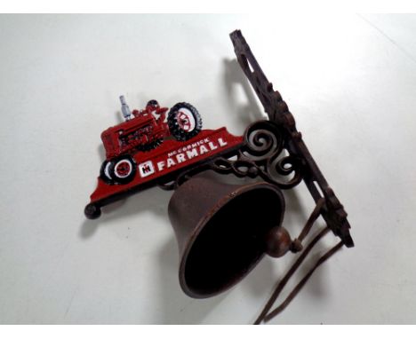 A  cast iron tractor wall bracket with bell 