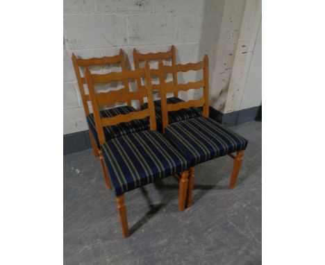 A set of four blond oak ladder back chairs 