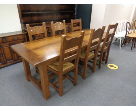 A good quality Siesta Chapman's refectory kitchen table, fitted two drawers, together with three pairs of ladder back rush se