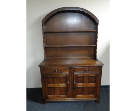 An Ercol elm and beech Dutch dresser in an oak finish  