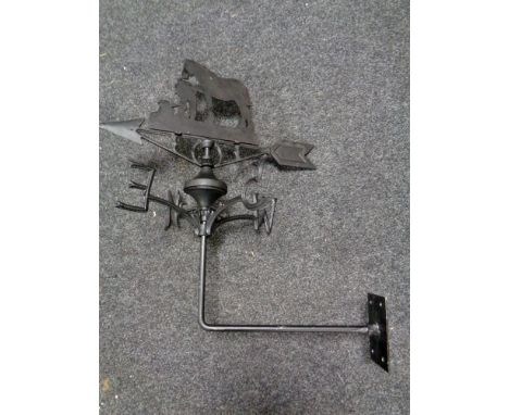 A cast iron blacksmith with horse weather vane 