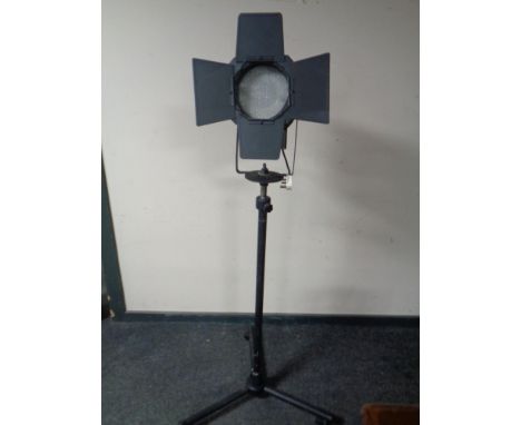 A theatre light on tripod stand 