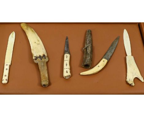 A 19th Century Inuit Snow Knife, Arctic, with marine ivory curved blade bound with sinew to the walrus tusk grip, 32cm; four 