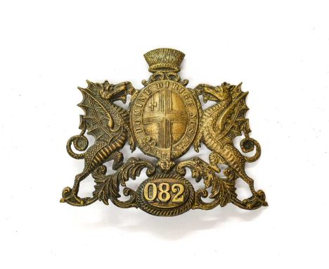 A City of London Helmet Plate, pre-1909, of die stamped blackened brass, as a coat of arms, the lower panel applied with bras