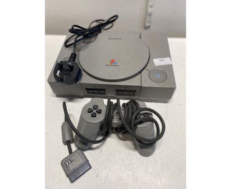 A Sony PlayStation with controller and power lead (powers up)