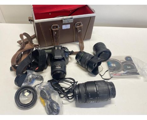 A Pentax K100 digital camera with an assortment of lenses (untested)