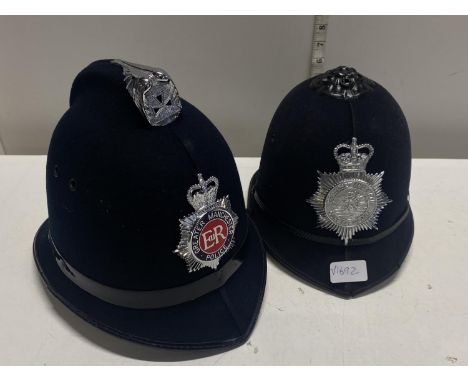 Two vintage police helmets, Manchester and Somerset and Bath