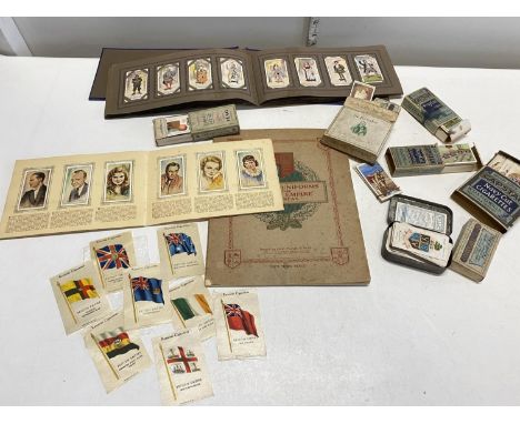 A selection of vintage cigarette card albums including silks