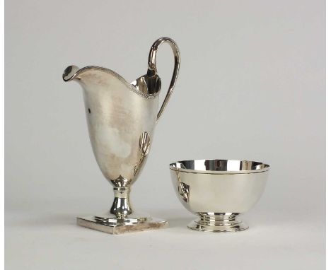 A George III style silver helmet cream jug, C S R Ltd, London 1974, 15.5cm high, together with a silver sugar bowl, Birmingha