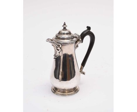 A George V silver hot water jug, Harrison Brothers &amp; Howson, London 1922, of blauster form with turned ebony handle, rais