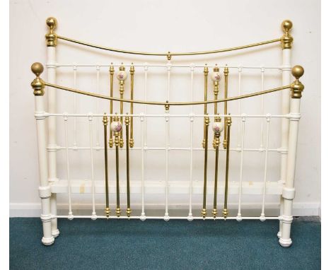 A painted iron and brass double bedstead by Seventh Heaven, with ceramic embellishments, with upholstered bed base, 156cm wid