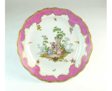 A large Meissen dishcirca 1820-30of moulded form, with wide puce scale scrolling border enclosing a centrally painted bucolic