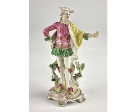 A Derby figure of a Ranelagh Dancer18th century,modelled as a gentleman standing holding a letter in his outstretched arm, on
