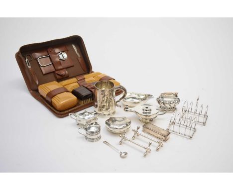 A small collection of silver, comprising; a mug, Sheffield 1922, a pair of four division toast racks, Birmingham 1916, a pap 