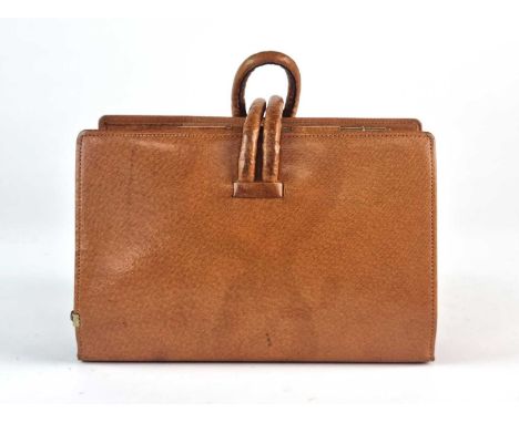 A Swaine-Brigg pigskin racing clutch bag, one outer section with pigskin cover for race cards, secured with a pen on a chain,