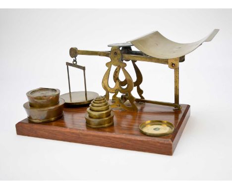 A late Victorian/Edwardian set of brass counter-top scales with a set of weights.
