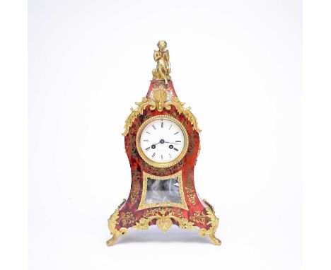 A late 19th century, Louis XV style, Buhl style mantel clock, with brass mounts, including a Cupid finial above a 3.25" circu