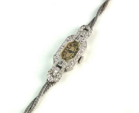 An Art Deco diamond set wristwatch, manual wind, the canted rectangular dial with black Roman numerals, within pave diamond s