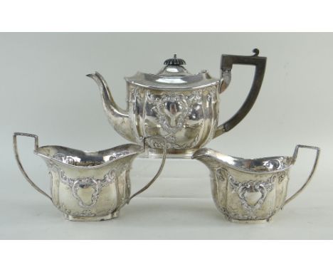 EDWARD VII SILVER THREE-PIECE BACHELORS TEA SET, Chester 1903, maker G N R H, with Rococo embossed decoration with blank cart