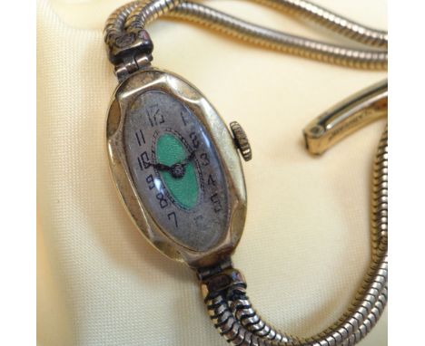 18CT GOLD LADIES WRISTWATCH, oval green guilloche enamel art deco dial engraved to reverse 'Daphne C Jones', the inside back 