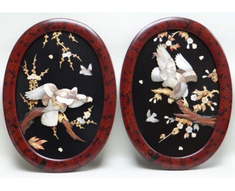 PAIR JAPANESE MOTHER OF PEARL &amp; BONE INLAID OVAL PLAQUES, decorated with eagles perches on flowering prunus branches, red