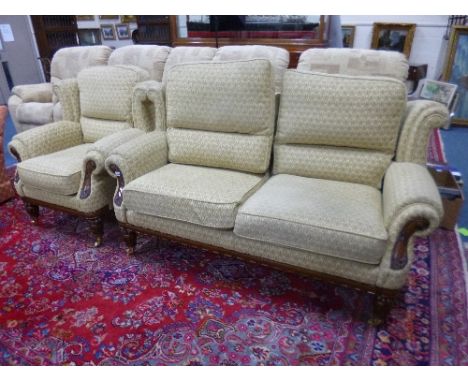 A BEIGE UPHOLSTERED TWO PIECE SUITE, with carved wood detail, comprising two seater sofa and a single armchair (sd)