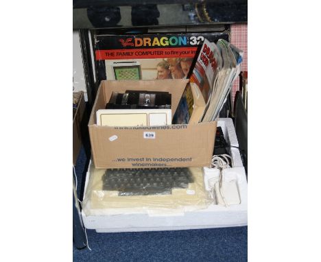 A DRAGON 32 VINTAGE COMPUTER SYSTEM, in its original box, complete with two joy sticks, PSU, manual, magazines and games in i