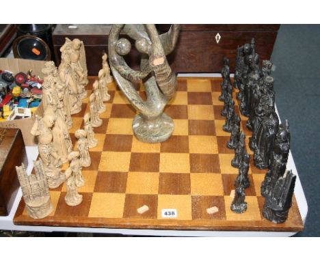 A LARGE CHESS SET AND BOARD, together with a large soapstone figure group