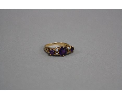 A LATE 20TH CENTURY AMETHYST AND CULTURED SPLIT PEARL HALF HOOP RING, three round mixed cut amethysts measuring from 4mm to 7