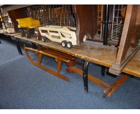 A VINTAGE WOODEN SLEDGE, a child's wooden scooter and two Tonka Toy trucks (4)