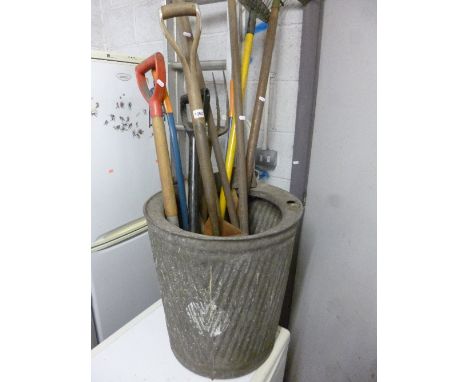 A GALVANISED BIN, containing a quantity of garden tools, a wheelbarrow and two deck chairs