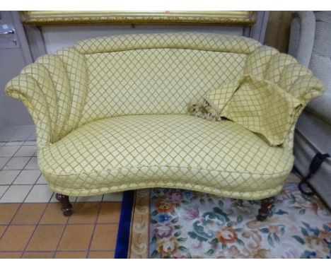 A VICTORIAN CURVED TWO SEATER SOFA, with lemon patterned upholstery