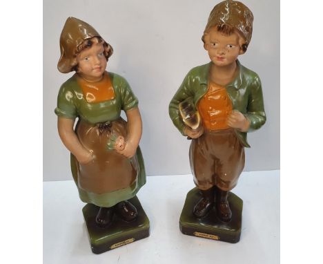 Pair of early 20thC Dutch ceramic figurines of a Dutch boy and girl both with plaques "Zuyder Zee",Both measure 43 cm 