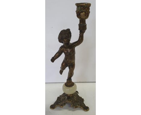 Solid brass and onyx candlestick in the form of a full-length Putti 