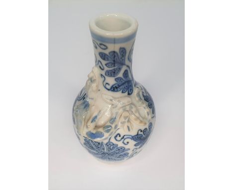 Small unmarked antique ceramic vase (9 cm tall) depicting a lizard climbing round the vase with blue foliage 