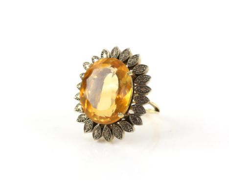 Vintage citrine cocktail ring, with a central oval cut citrine, estimate weight 25.00 carats, surrounded by a leaf motif and 