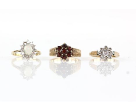 Three cluster rings, including an opal and paste set cluster ring, ring size L and a vintage red paste cluster ring, size N 1