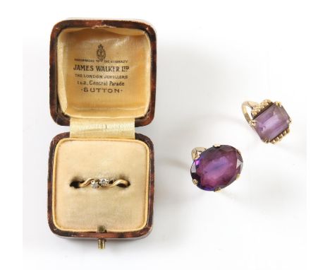 Three rings, including, a diamond two stone ring, in a twist setting, in 18 ct yellow gold, size K 1/2, and two amethyst cock