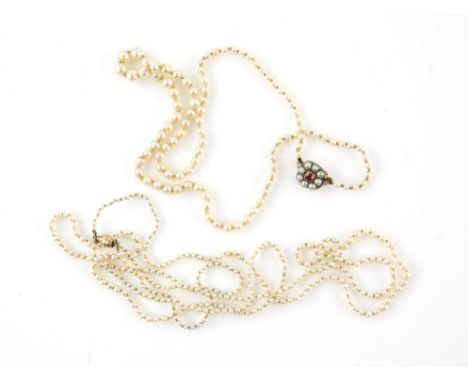 Two pearl necklaces, featuring a graduated pearl necklace, strung with knots, with a seed pearl and ruby clasp in tested 9 ct