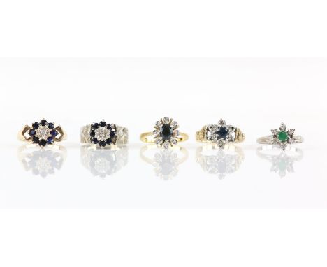 Five cluster rings, including an emerald and diamond floral cluster, in white gold mount testing as 18 ct white gold, ring si