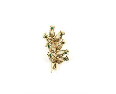 Boucheron floral brooch, set with round cut emeralds, with hinged double prong fitting, signed Boucheron, Made in France, in 