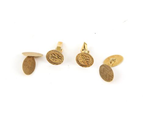 Two pairs of cufflinks, including, a pair of oval engine turned cufflinks, in 18 ct yellow gold, and a pair of circular Asian