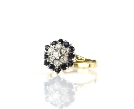 Vintage diamond and sapphire cluster ring, set with seven round brilliant cut diamonds, estimated total diamond weight 0.70 c