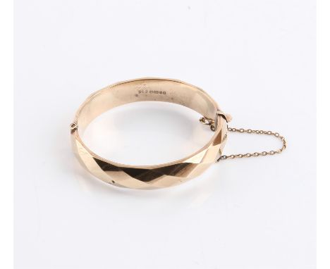 1970's faceted hinged bangle, with concealed clasp and safety chain, in 9 ct yellow gold, hallmarked Birmingham 1977, S & P m