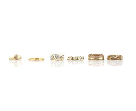 Six rings, including a 1930's 22 ct wedding band, a vintage tri coloured gold ring, a cut out signet ring with the initials R